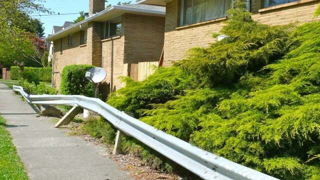If you lived here, you could have a car in your living room by now. This 24th Ave E & Montlake Blvd apartment's guard rail is put to heavy use each year. (Photo: MvB) 