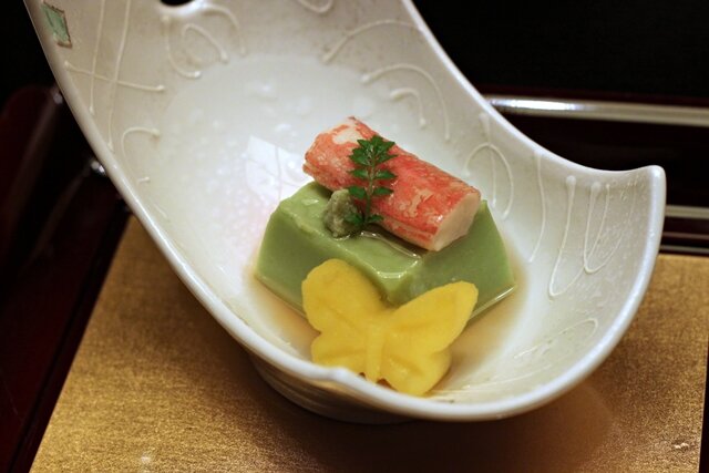 Part of the starter: endomame tofu (tofu texture, made from endomame peas) with crab and kabocha butterfly (along with wasabi and a sansho leaf)