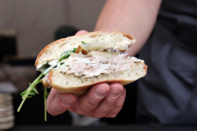 Ethan Stowell showing off his pork belly porchetta sandwich with Bosc pear and onion mostarda (big portion and big flavor)
